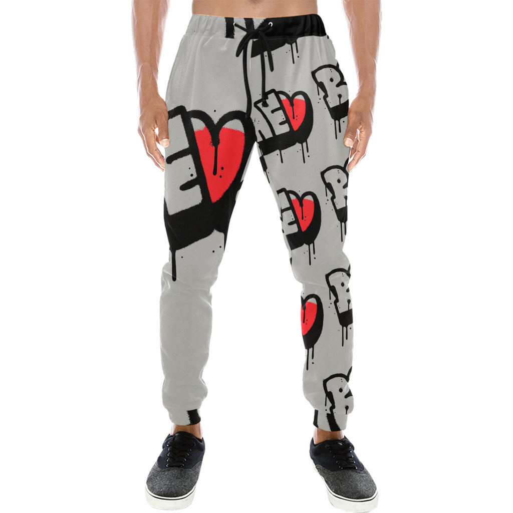 Person wearing graphic print jogger pants with red and black heart designs and black sneakers.