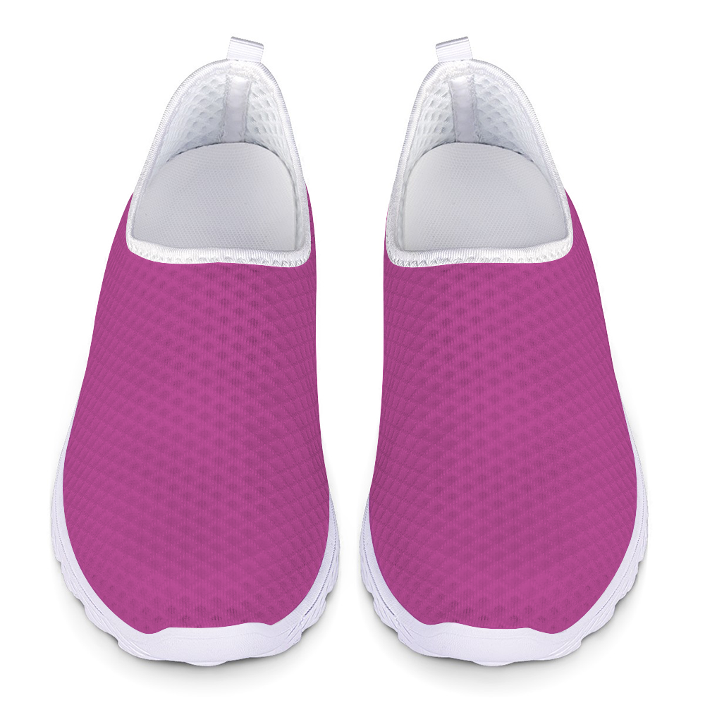 The Melanin Love Cushion Kicks are stylish slip-on sneakers in pink, featuring a slip-resistant white sole and a perforated mesh fabric design.