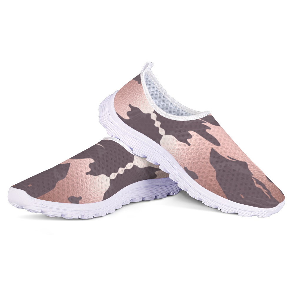 The Fall Flow Cushion Kicks are slip-on athletic shoes with a white sole and a camouflage pattern in pink, brown, and gray tones, featuring breathable mesh for maximum comfort.