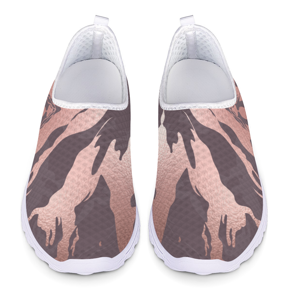 The Fall Flow Cushion Kicks are slip-on athletic shoes with a white sole and a camouflage pattern in pink, brown, and gray tones, featuring breathable mesh for maximum comfort.