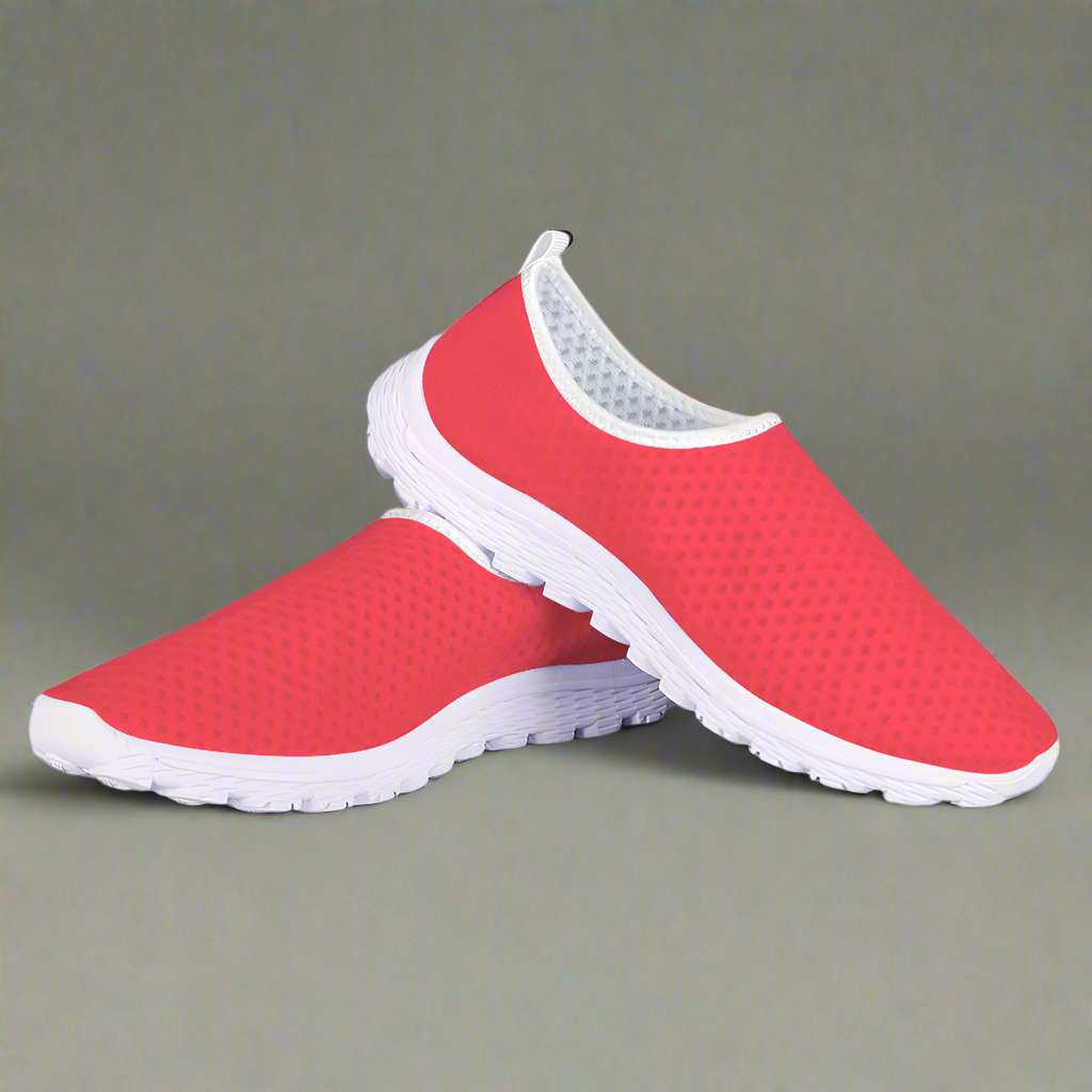 The Unstoppable Hustle Kushion Kicks feature a single red slip-on design with a white sole and mesh fabric, angled slightly to the side, ideal for fans of athletic sport shoes.
