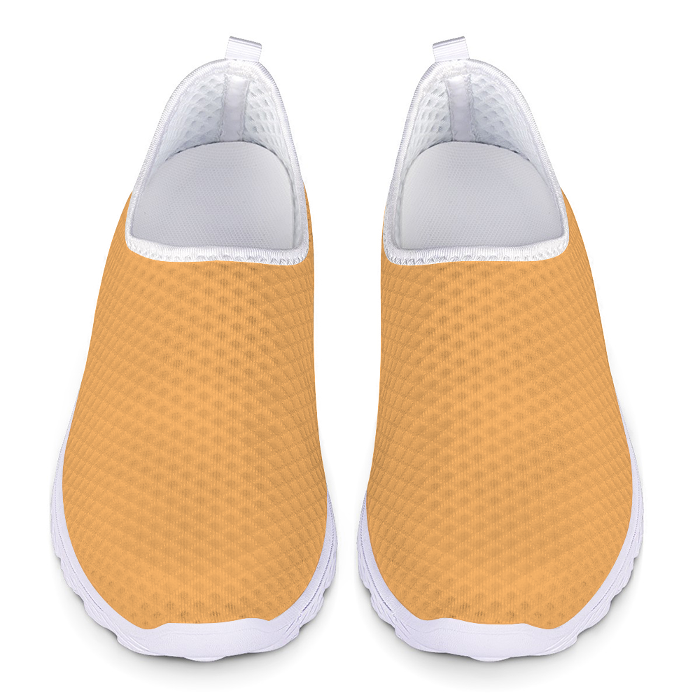 The Sophisticated Glamour Cushion Kicks feature a slip-on design with a yellow textured mesh fabric upper, complemented by a sleek white sole.