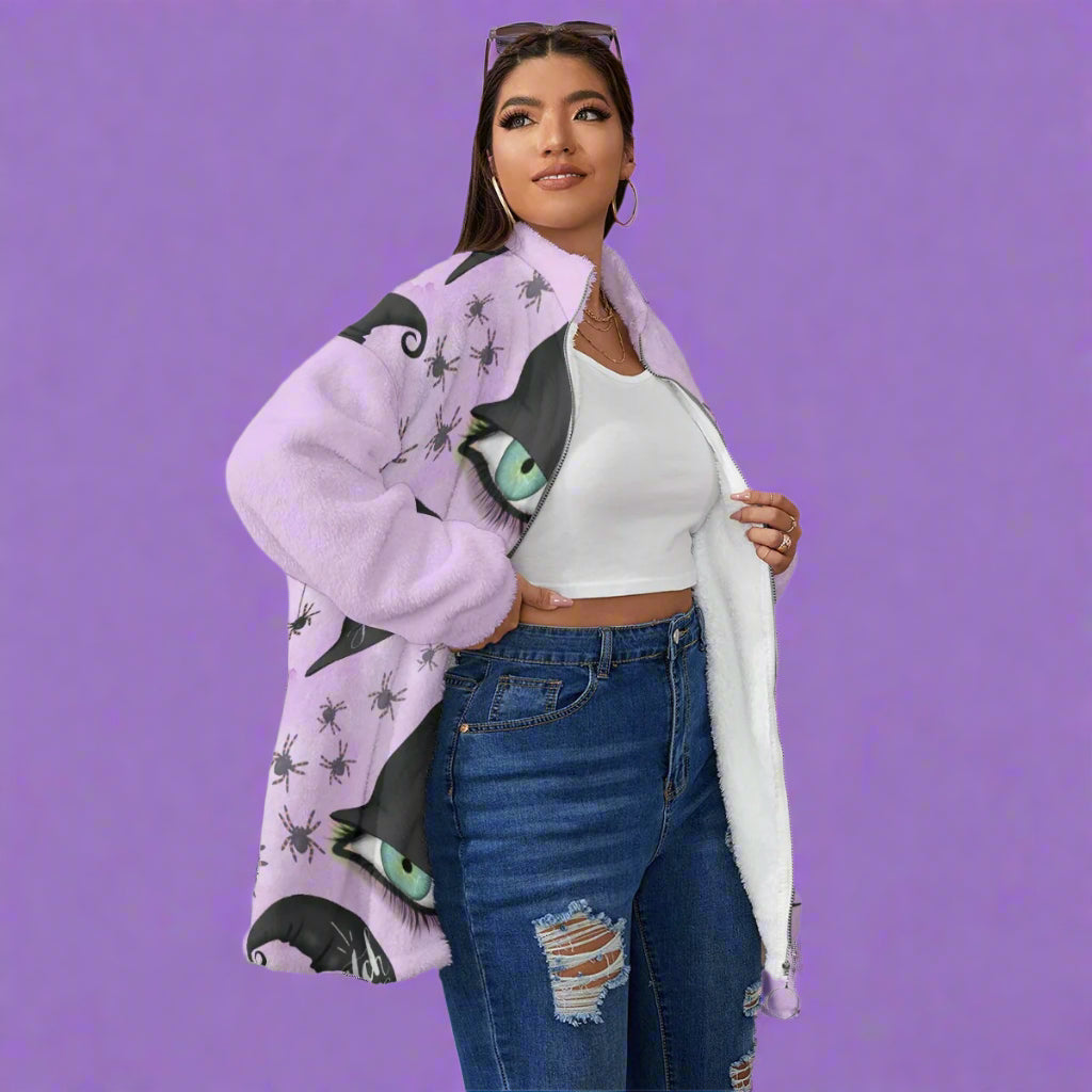 Woman wearing a purple cardigan with cat eye design, white top, and blue jeans on a white background