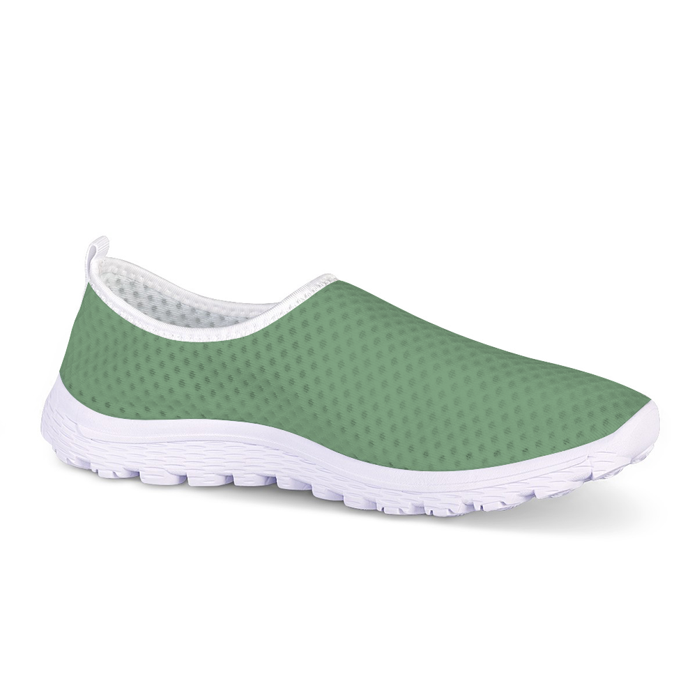 The Sunny Sophistication Cushion Kicks are green slip-on sneakers with a white sole and mesh fabric design, ideal walking shoes due to their slip-resistant features.