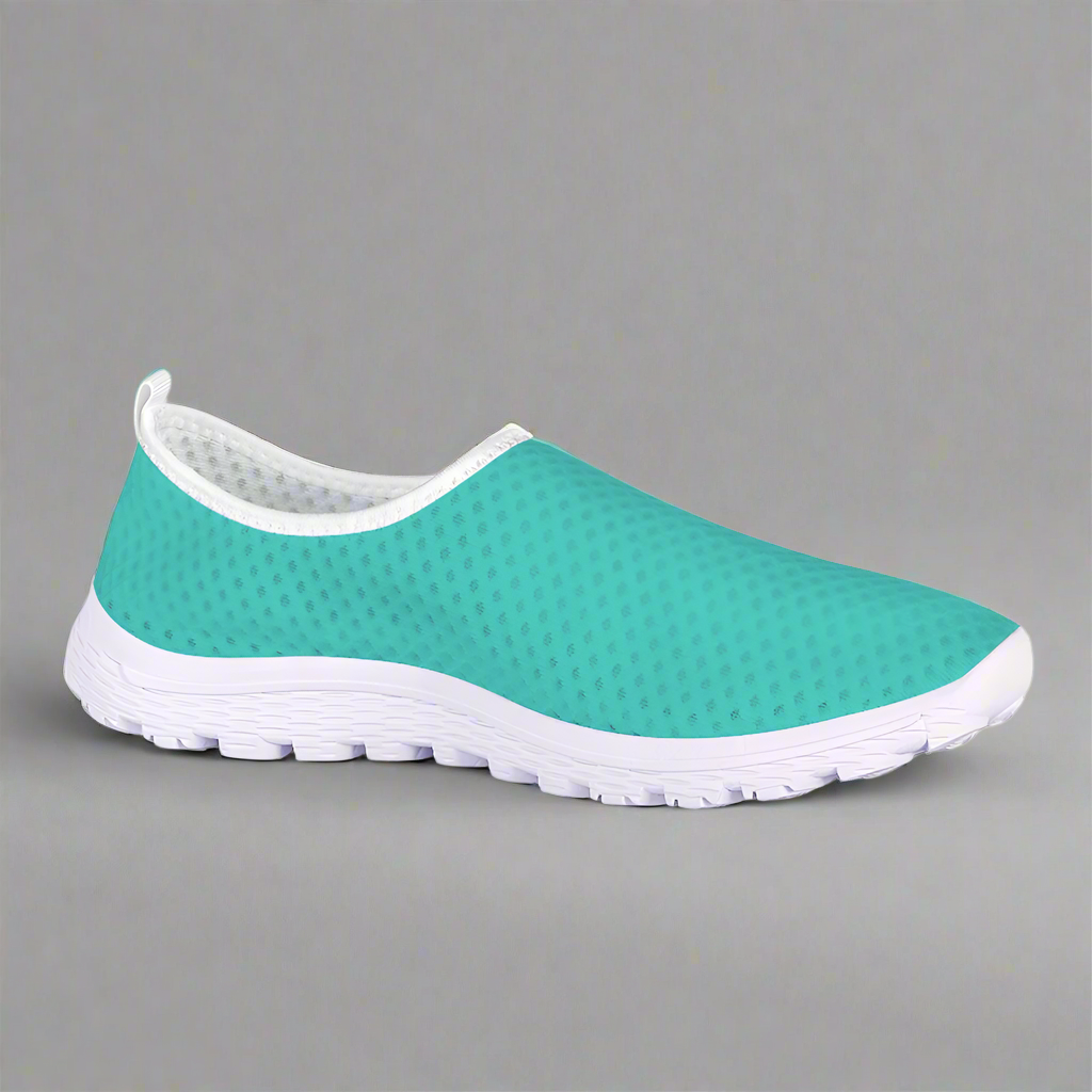 The She's a Vibe 40 Cushion Kicks in teal showcases a breathable mesh upper and a sleek white sole, blending comfort with style.