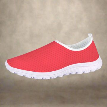 The Unstoppable Hustle Kushion Kicks feature a single red slip-on design with a white sole and mesh fabric, angled slightly to the side, ideal for fans of athletic sport shoes.