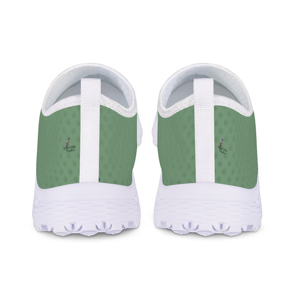 The Sunny Sophistication Cushion Kicks are green slip-on sneakers with a white sole and mesh fabric design, ideal walking shoes due to their slip-resistant features.