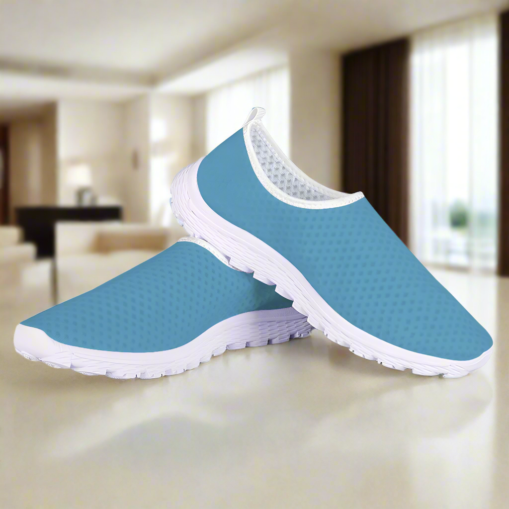 Introducing the "Not Here To Play Nice Cushion Kicks," a slip-on sneaker in sky blue with a white sole, designed with a breathable mesh upper and slip-resistant grip.