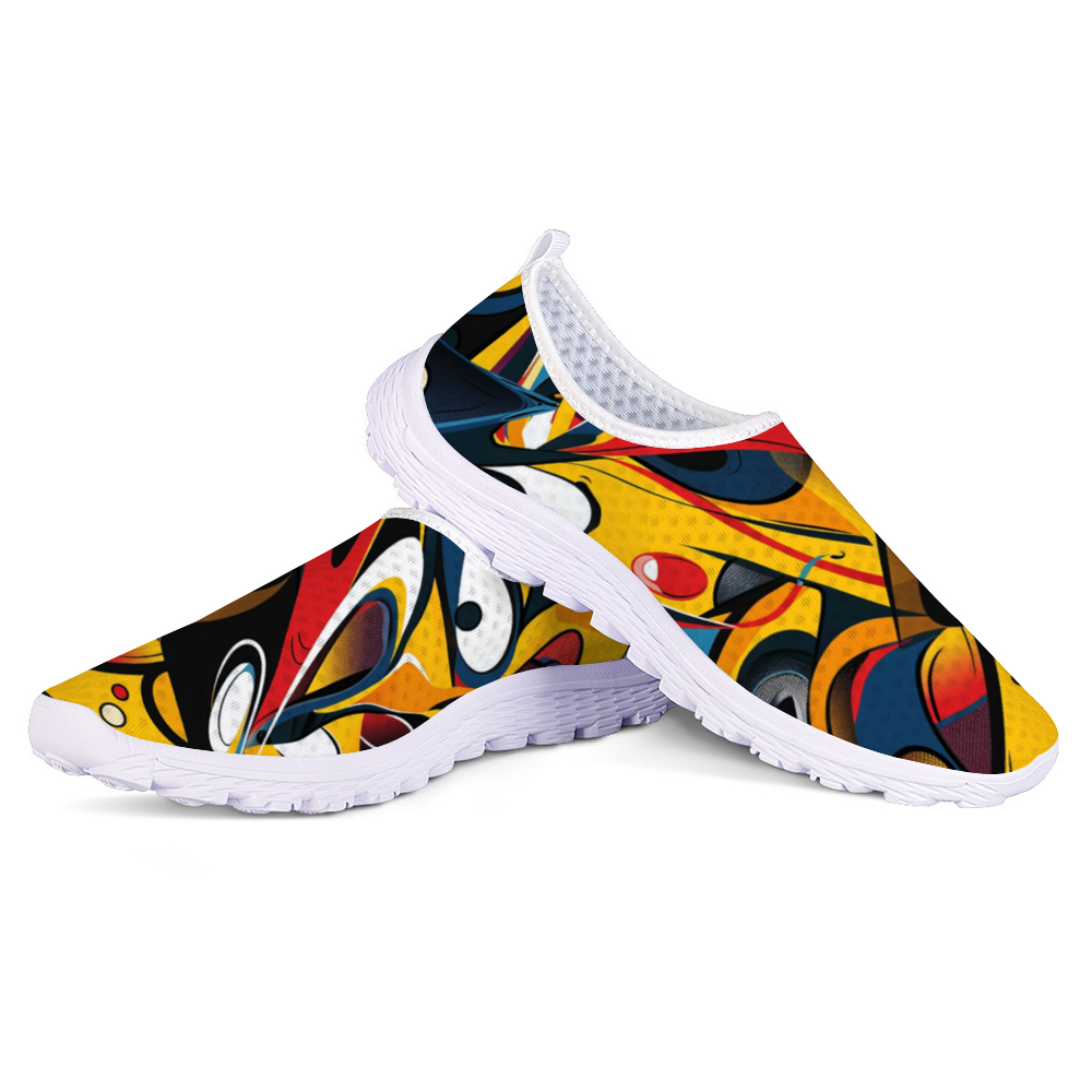 Funky Femme Cushion Kicks are stylish white slip-on walking shoes adorned with a colorful, abstract design featuring vibrant red, yellow, blue, and black shapes. Perfect for daily wear, these trendy sneakers offer slip-resistant soles for enhanced safety and comfort.