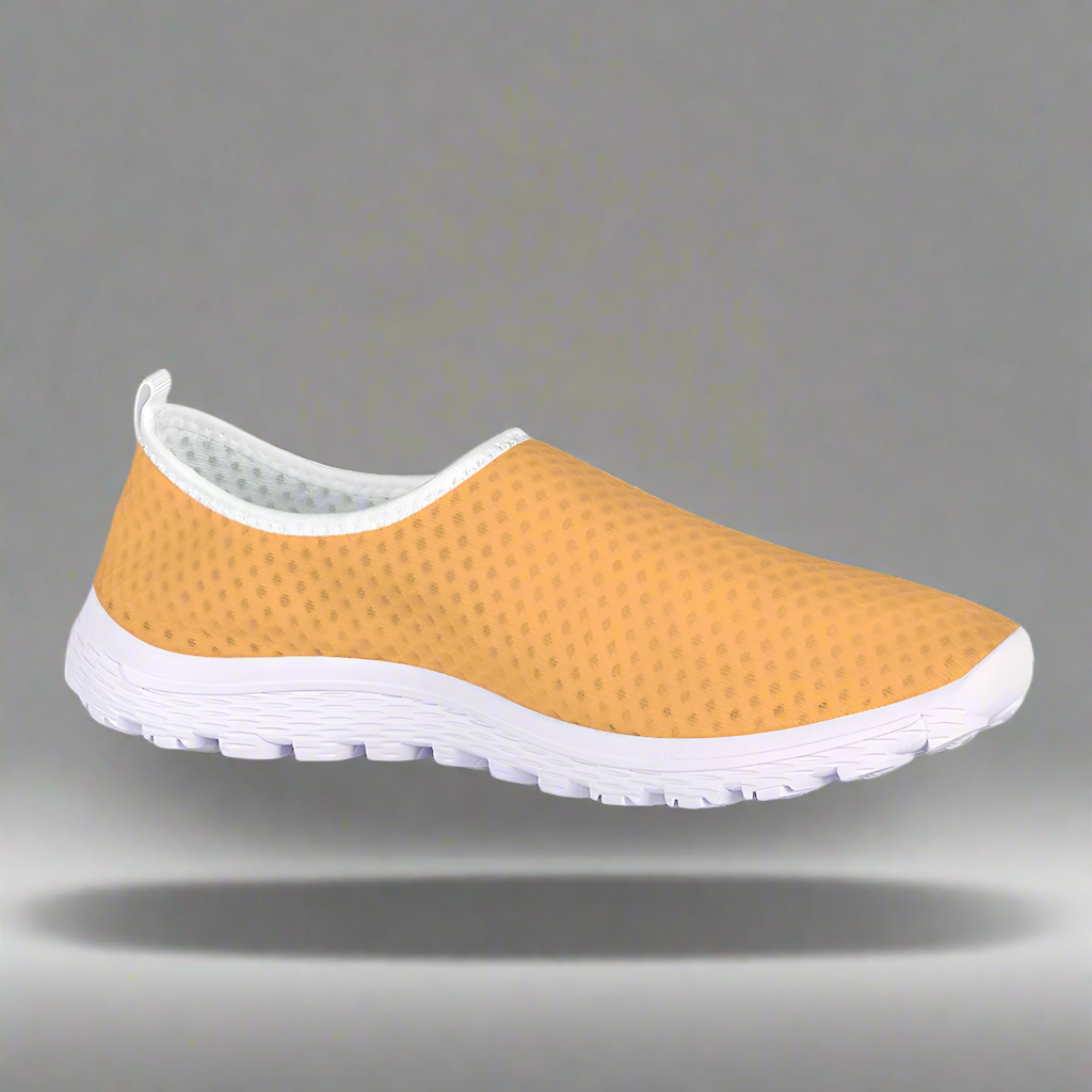 The Sophisticated Glamour Cushion Kicks feature a slip-on design with a yellow textured mesh fabric upper, complemented by a sleek white sole.