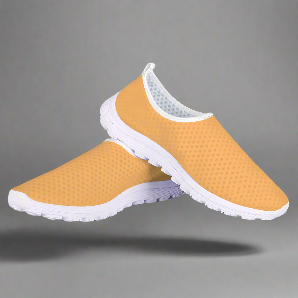 The Sophisticated Glamour Cushion Kicks feature a slip-on design with a yellow textured mesh fabric upper, complemented by a sleek white sole.