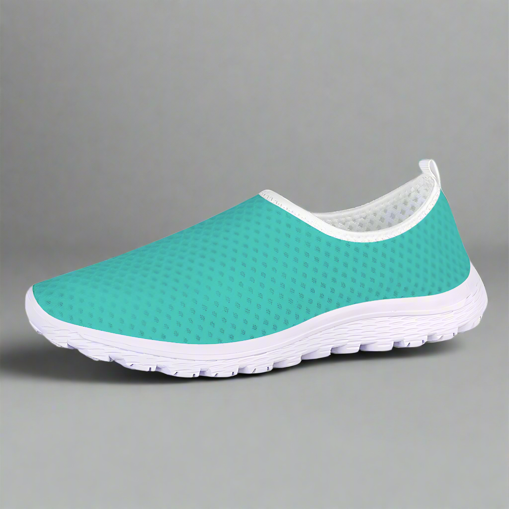 The She's a Vibe 40 Cushion Kicks in teal showcases a breathable mesh upper and a sleek white sole, blending comfort with style.