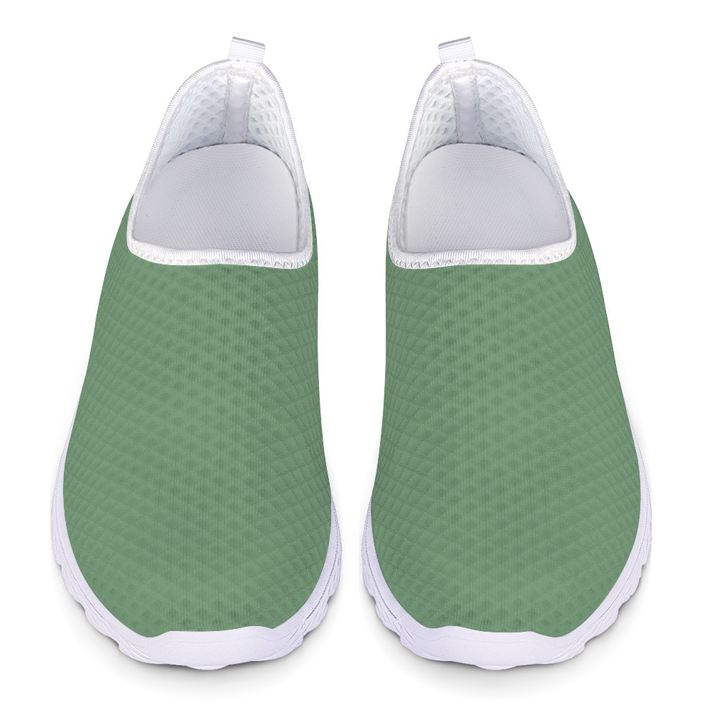 The Sunny Sophistication Cushion Kicks are green slip-on sneakers with a white sole and mesh fabric design, ideal walking shoes due to their slip-resistant features.