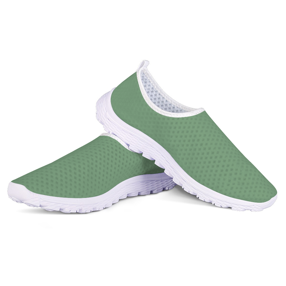 The Sunny Sophistication Cushion Kicks are green slip-on sneakers with a white sole and mesh fabric design, ideal walking shoes due to their slip-resistant features.